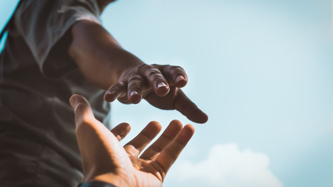 A helping hand reaching out, symbolic of seeking help.