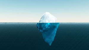 An iceberg illustration depicting trauma - visible symptoms above the water and underlying issues beneath the surface.