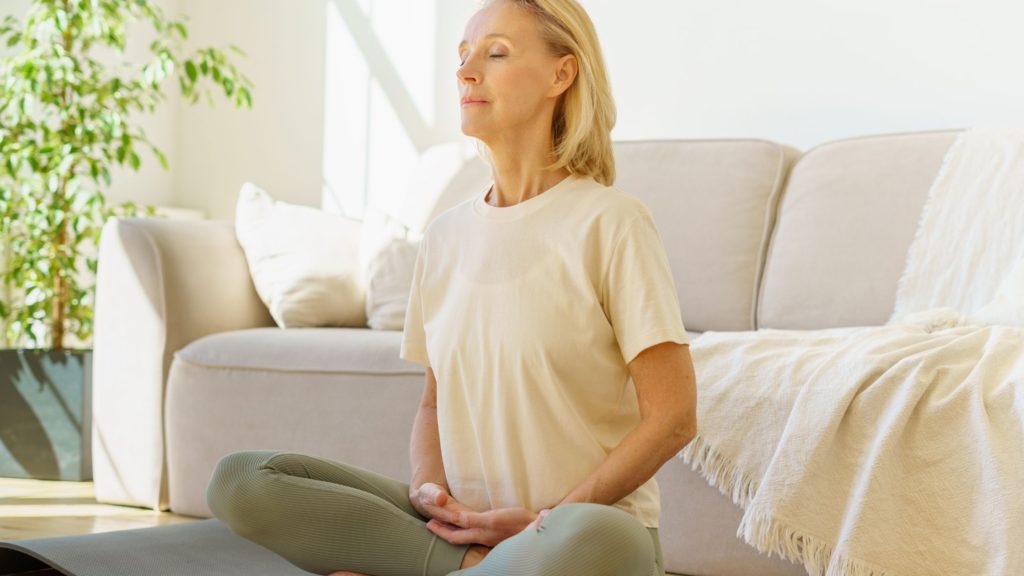 A person meditating in a peaceful environment, practicing acceptance and commitment therapy