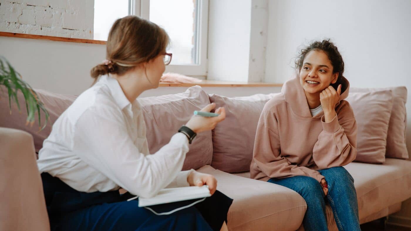 A person talking to a therapist, looking relaxed and comfortable
