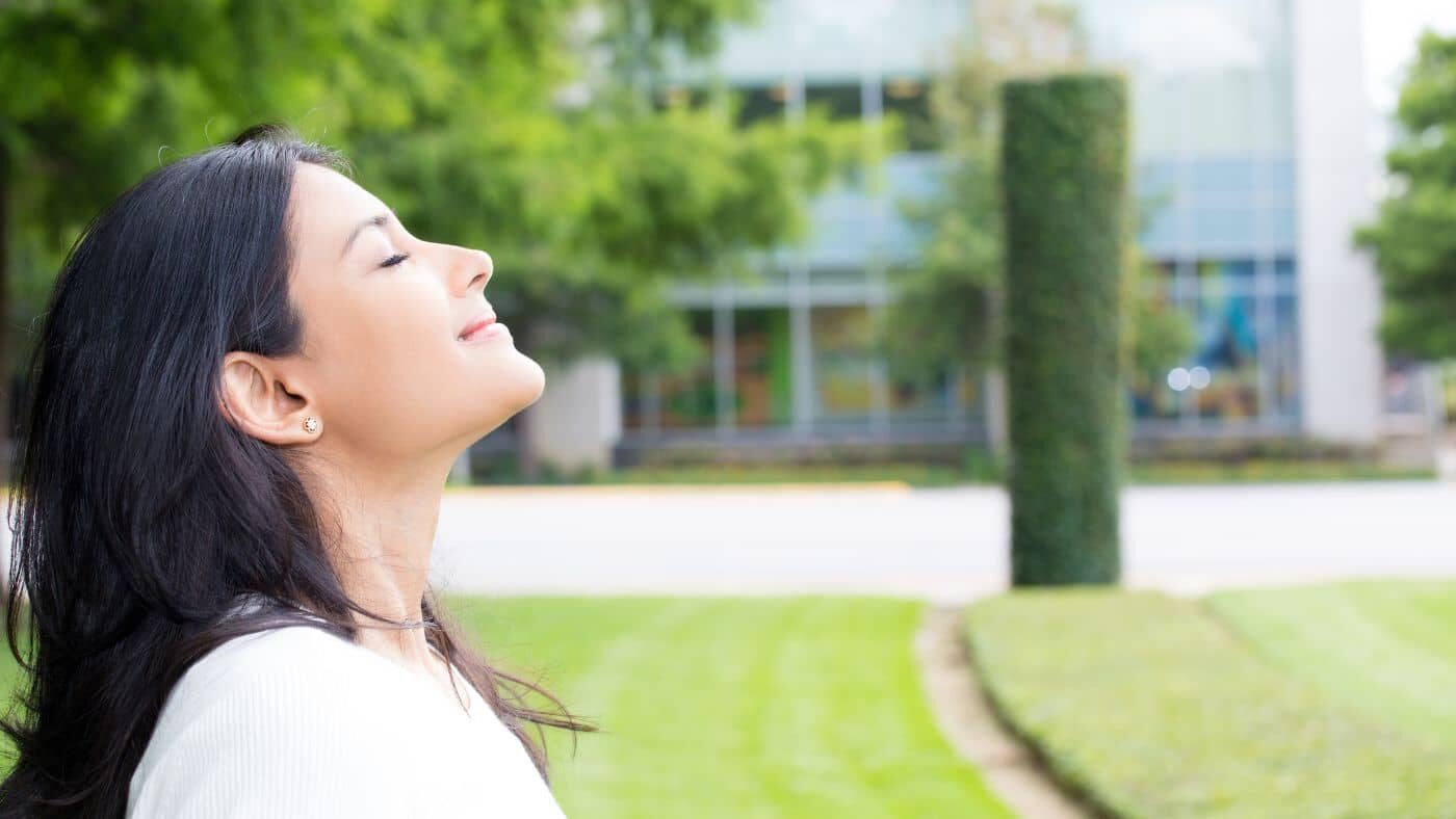 A person outdoors, enjoying the fresh air and feeling energized
