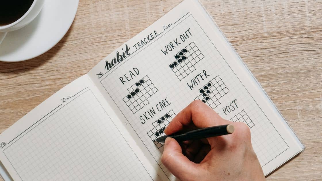 Using a notepad to track your habit agenda.